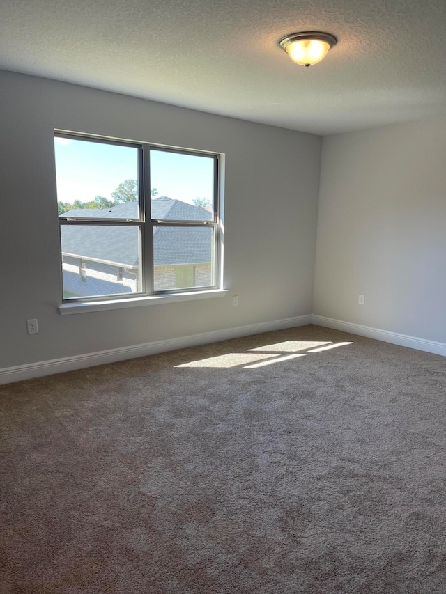 carpeted spare room with a textured ceiling and a water view