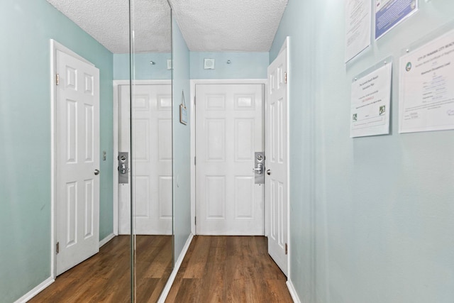 interior space featuring dark wood-type flooring and a textured ceiling