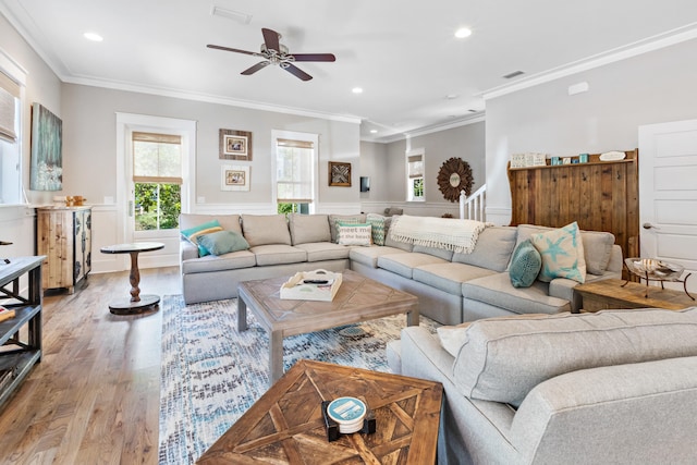 living room featuring light hardwood / wood-style floors, crown molding, and ceiling fan