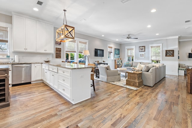 kitchen featuring decorative light fixtures, dishwasher, white cabinetry, and light hardwood / wood-style flooring