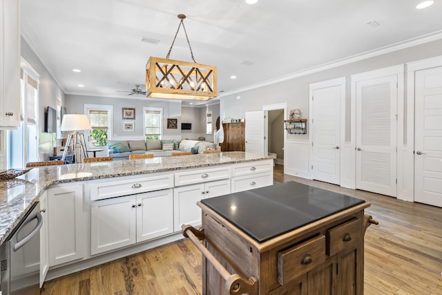 kitchen featuring light hardwood / wood-style floors, ceiling fan, white cabinetry, and light stone counters