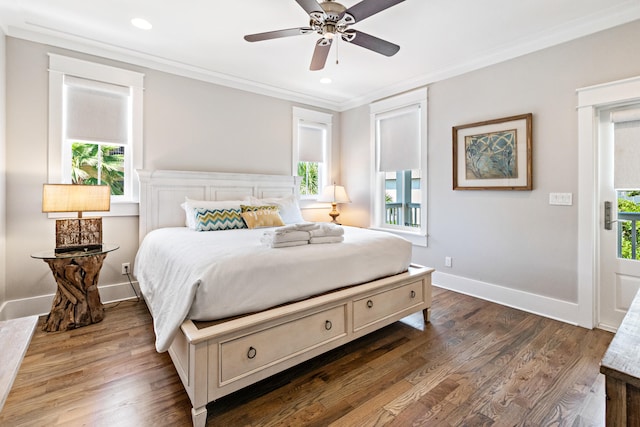 bedroom featuring ornamental molding, dark wood-type flooring, and ceiling fan