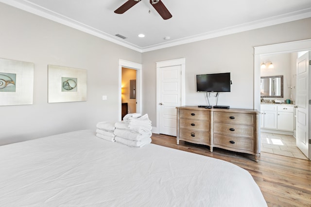 bedroom with ornamental molding, ensuite bath, light hardwood / wood-style floors, and ceiling fan