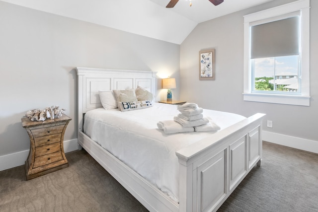 bedroom featuring ceiling fan, dark carpet, and lofted ceiling