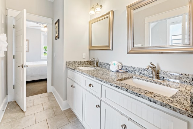 bathroom with tile floors, ceiling fan, dual vanity, and a wealth of natural light