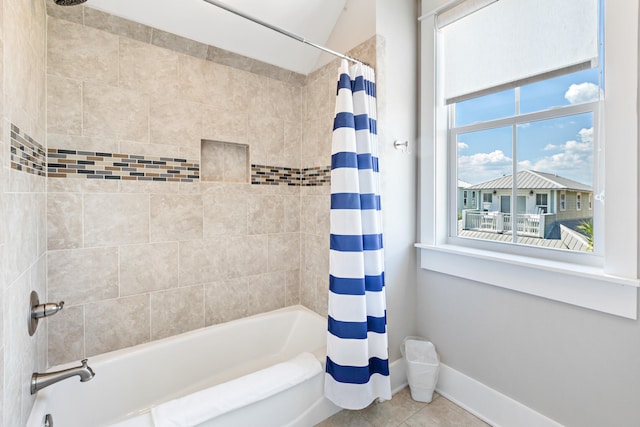 bathroom featuring shower / bathtub combination with curtain, toilet, and tile floors