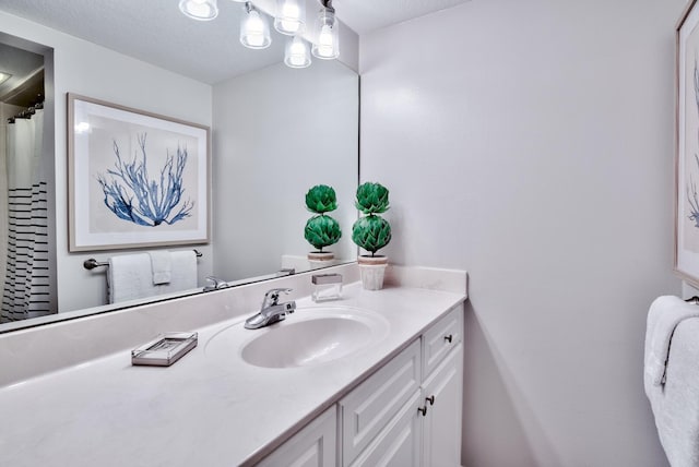 bathroom with a textured ceiling and vanity