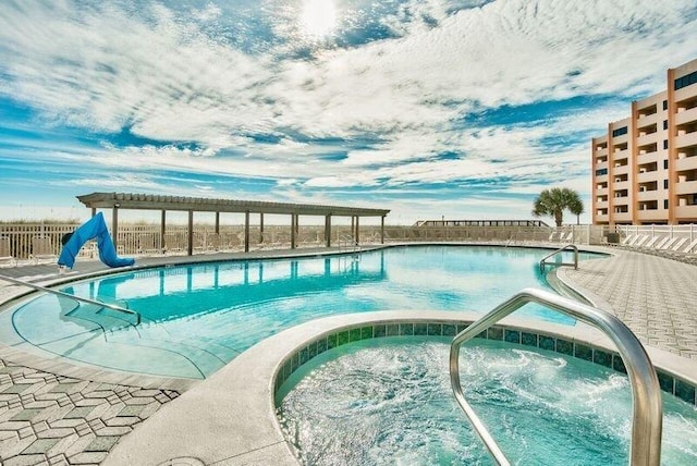 view of swimming pool featuring a community hot tub