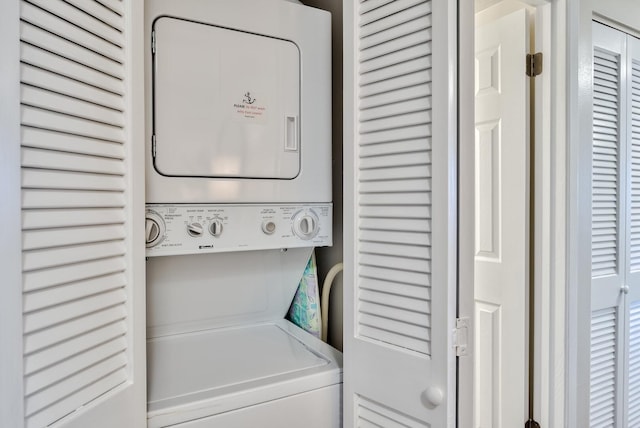 clothes washing area with stacked washer and dryer