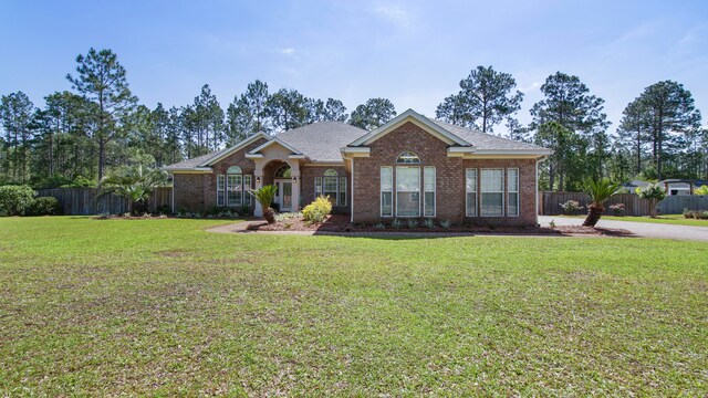 ranch-style home featuring a front yard