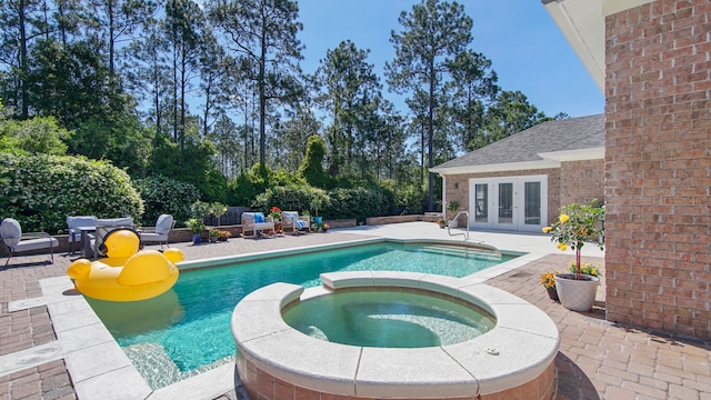 view of swimming pool with an in ground hot tub, french doors, and a patio