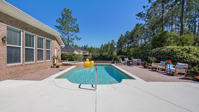 view of swimming pool with an in ground hot tub and a patio