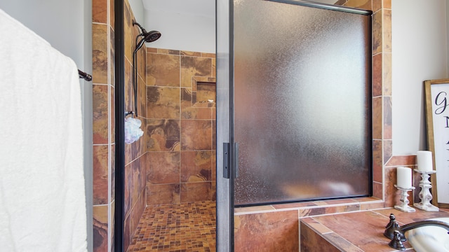 bathroom featuring a shower with shower door