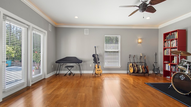 interior space featuring hardwood / wood-style flooring, ceiling fan, and crown molding