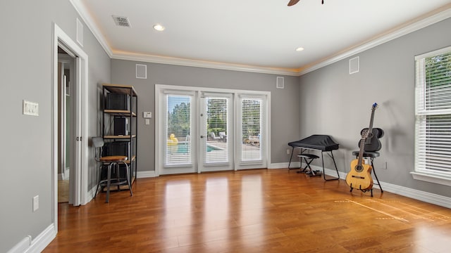 interior space featuring crown molding, ceiling fan, and hardwood / wood-style flooring