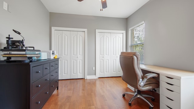 office with ceiling fan and light hardwood / wood-style flooring