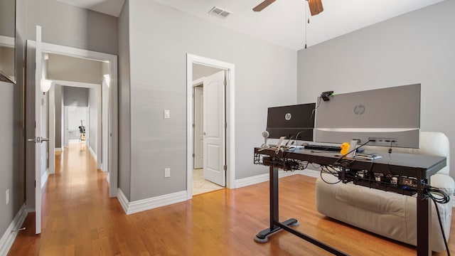 home office featuring hardwood / wood-style flooring and ceiling fan