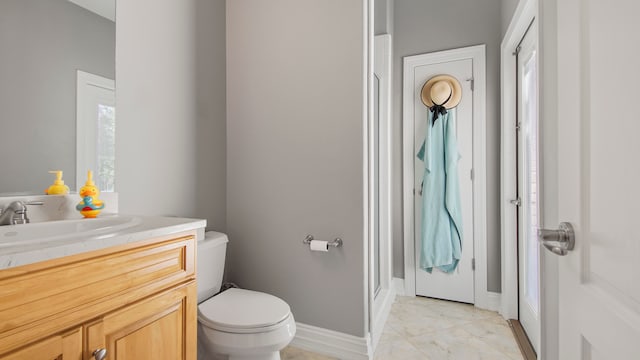 bathroom with vanity, toilet, and walk in shower