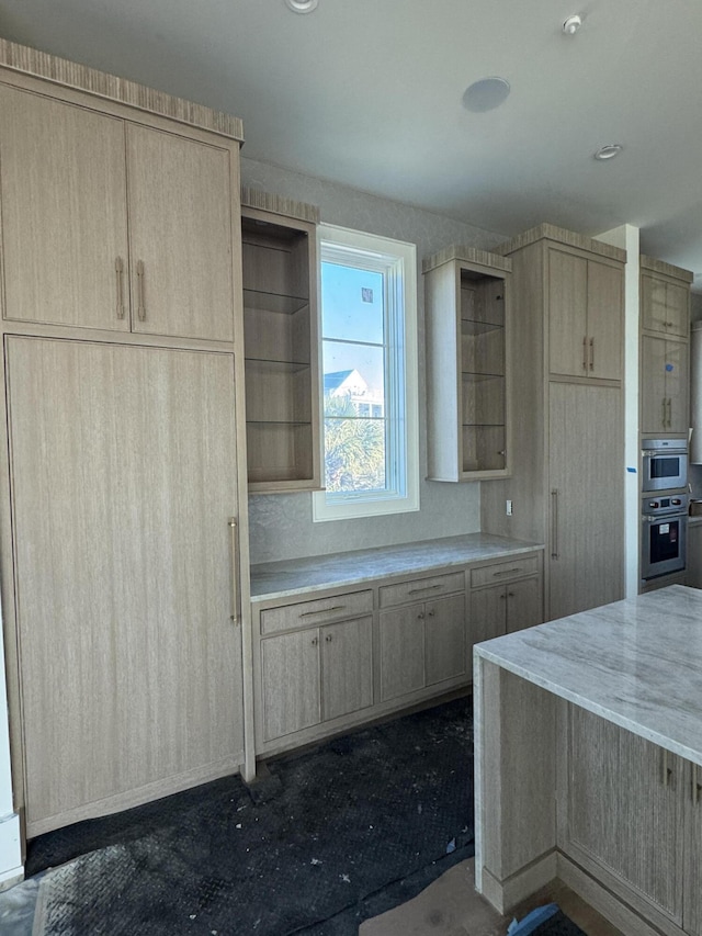 kitchen featuring stainless steel double oven and light brown cabinetry