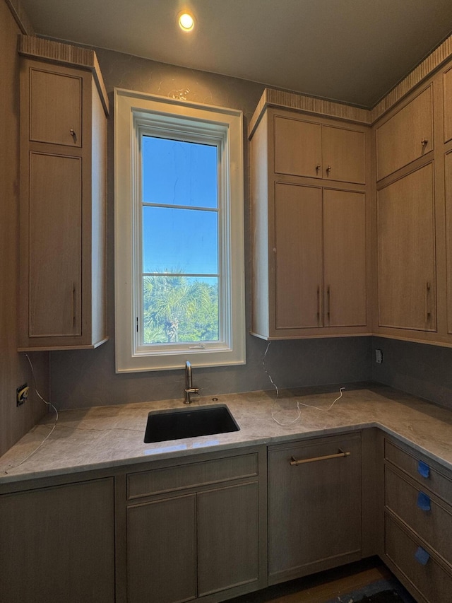 kitchen featuring light countertops, a sink, and recessed lighting