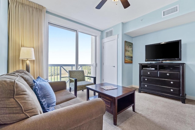 carpeted living room with ceiling fan