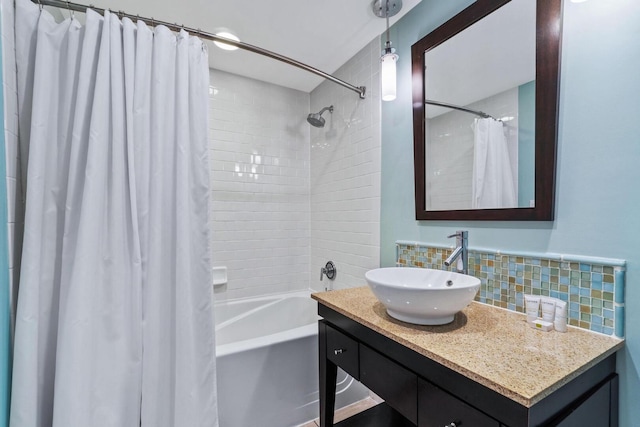 bathroom featuring backsplash, vanity, and shower / bath combo with shower curtain