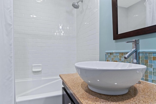 bathroom with tile walls, shower / bath combo, and vanity with extensive cabinet space