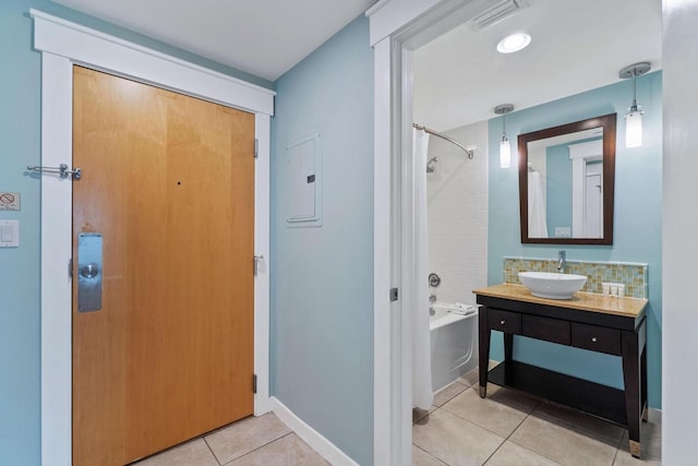 interior space with washtub / shower combination, vanity, and tile flooring