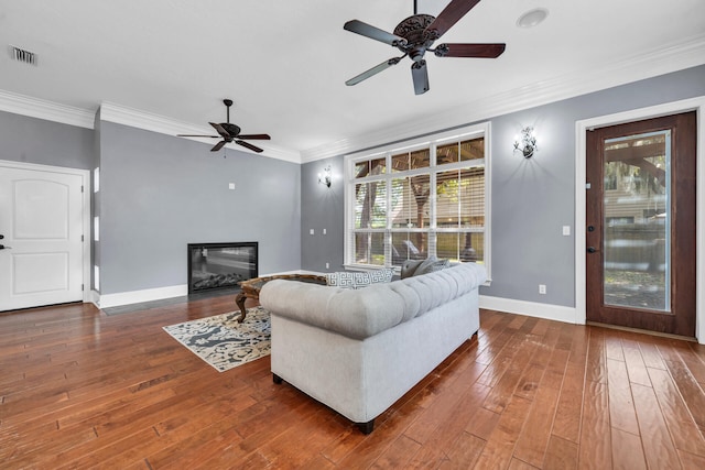 living room with ornamental molding, dark hardwood / wood-style flooring, and ceiling fan