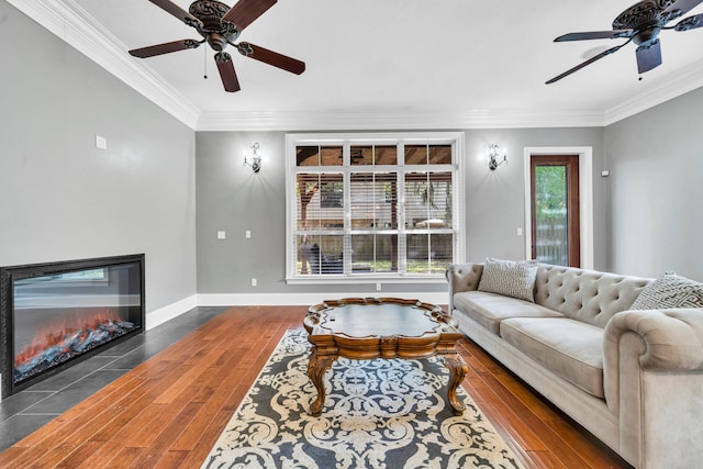 living room featuring dark hardwood / wood-style flooring, ceiling fan, and crown molding