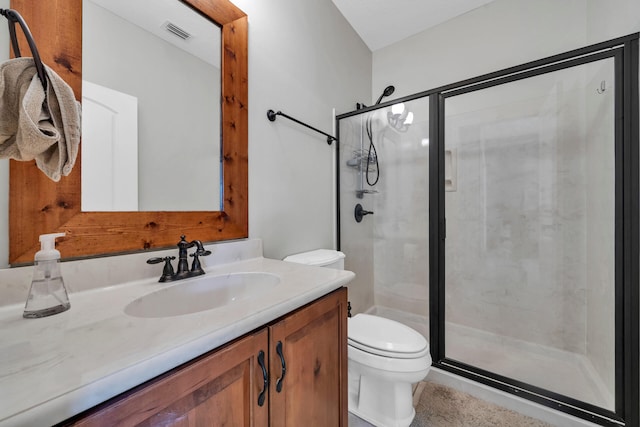 bathroom featuring walk in shower, oversized vanity, and toilet