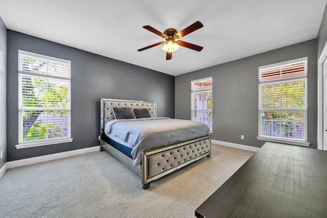 bedroom featuring ceiling fan and light carpet