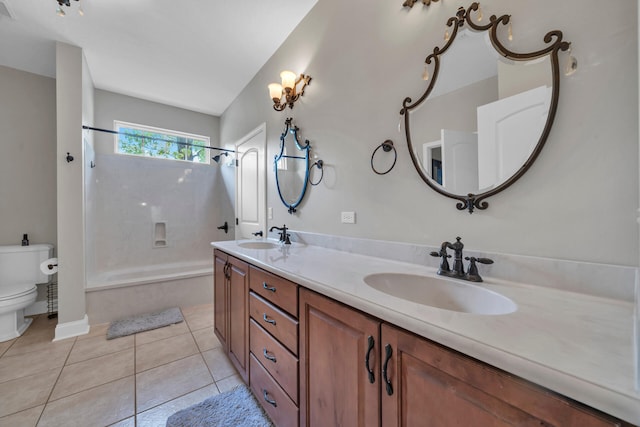 bathroom with toilet, tile flooring, and double vanity