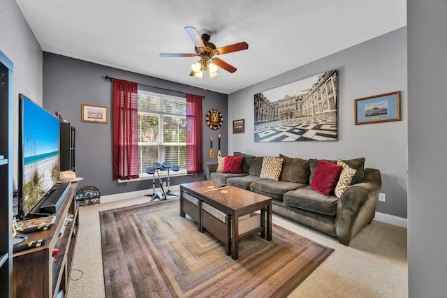 carpeted living room with ceiling fan