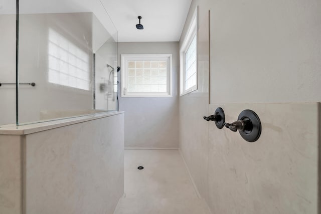 bathroom featuring walk in shower and concrete flooring