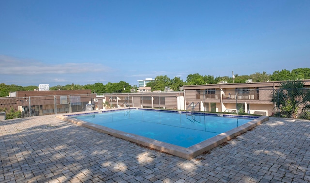 view of swimming pool with a patio