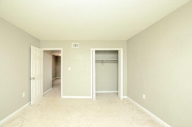 401 Marshall Ct NW Unit 2, Fort Walton Beach, FL 32548 - unfurnished bedroom featuring light carpet, baseboards, and a closet