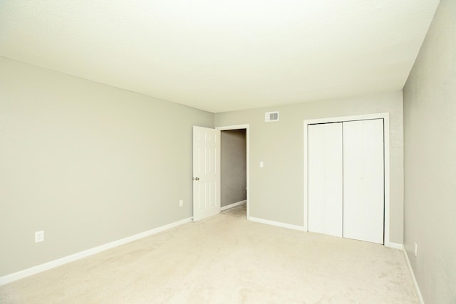 401 Marshall Ct NW Unit 2, Fort Walton Beach, FL 32548 - unfurnished bedroom featuring light colored carpet, a closet, and baseboards