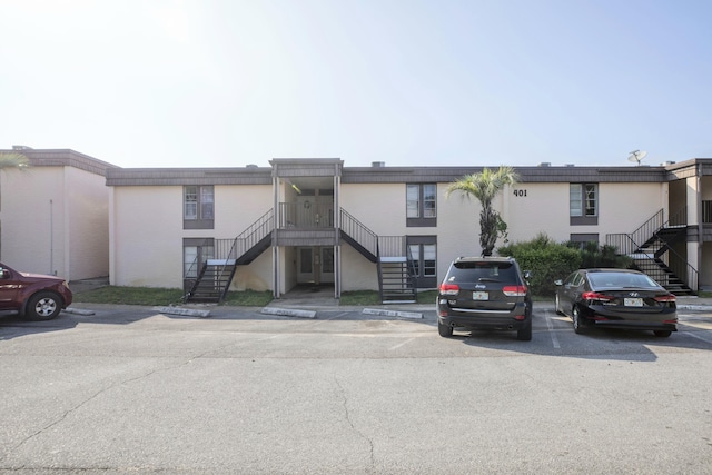 401 Marshall Ct NW Unit 2, Fort Walton Beach, FL 32548 - view of building exterior featuring stairway and uncovered parking