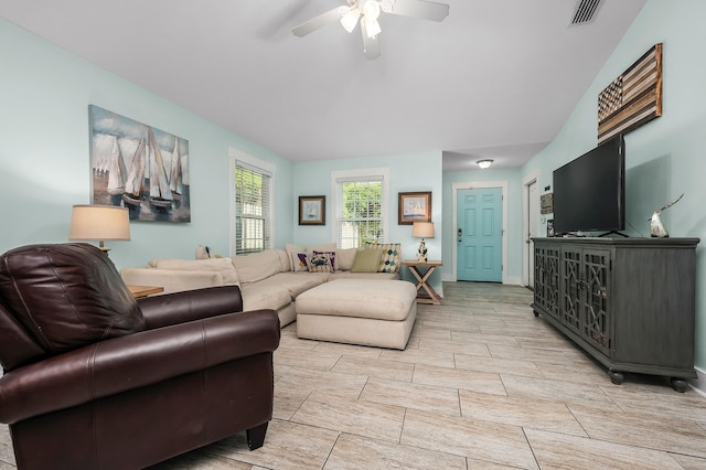 tiled living room with ceiling fan