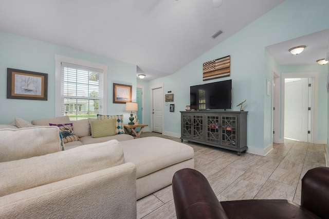 living room featuring vaulted ceiling