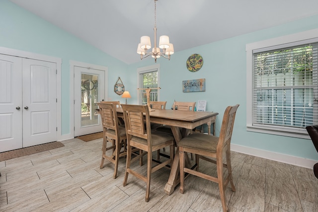 dining room with lofted ceiling and a chandelier