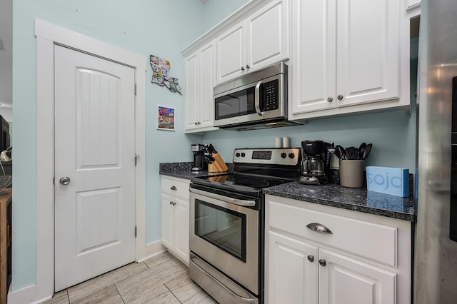 kitchen with appliances with stainless steel finishes and white cabinetry