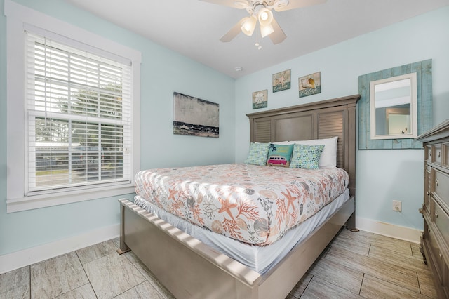 tiled bedroom featuring ceiling fan and multiple windows