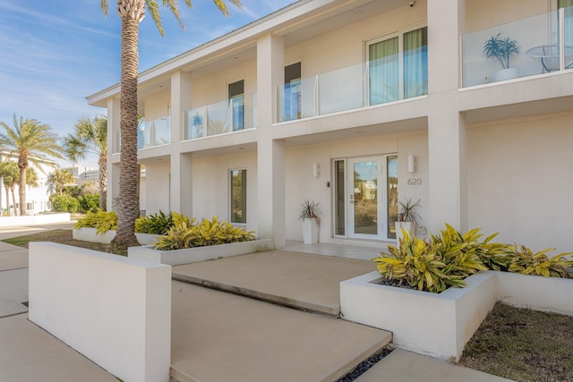 entrance to property featuring stucco siding