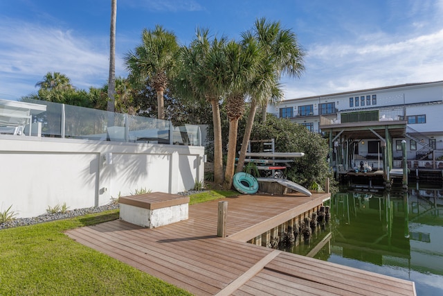 view of dock featuring a water view and fence