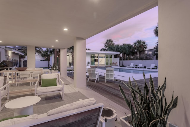 view of patio / terrace featuring a community pool, fence, and outdoor dining area