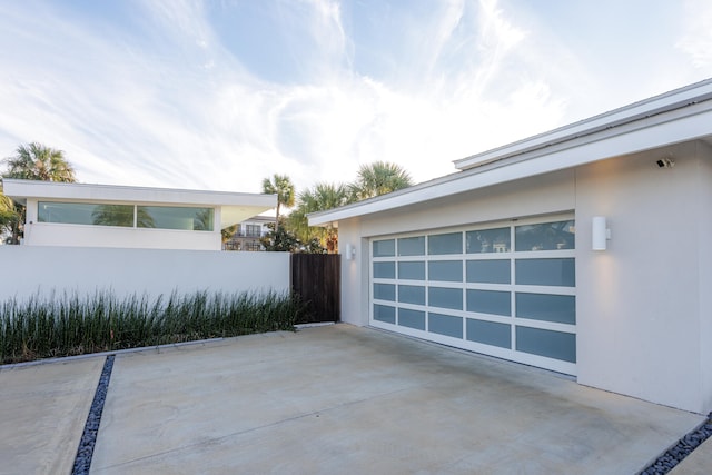 view of patio featuring a garage and fence