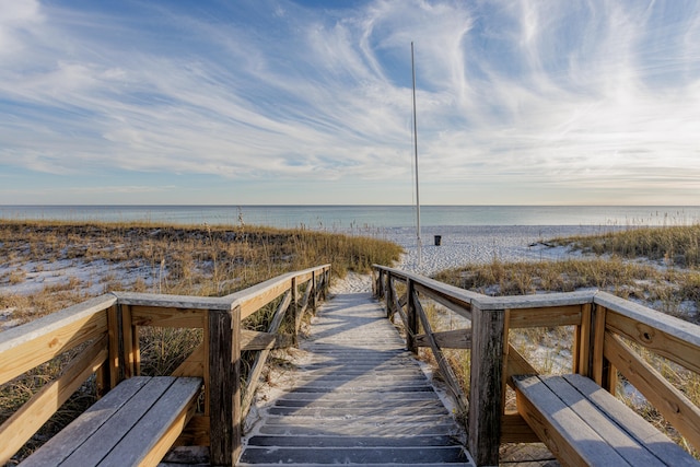 surrounding community featuring a water view and a view of the beach