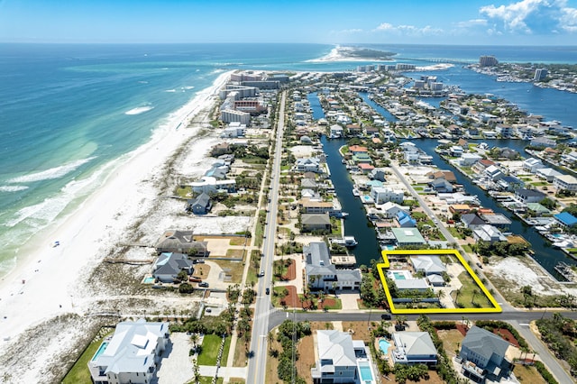 birds eye view of property with a beach view and a water view